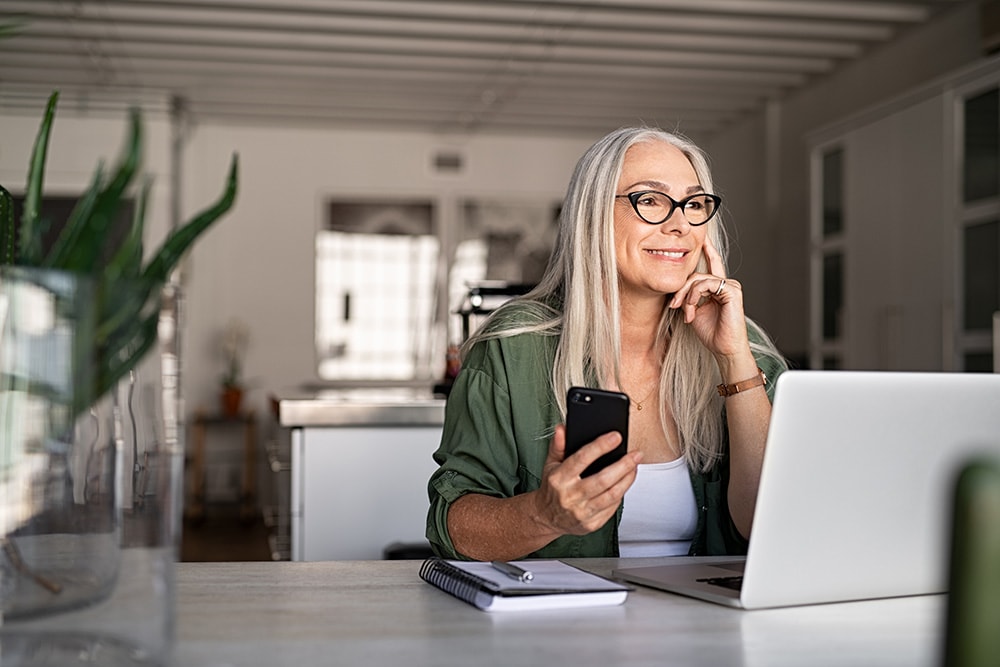 woman on computer and phone